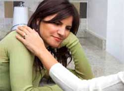 Woman with a hand on her shoulder